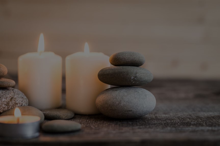 A softly lit Hand & Stone Massage and Facial Spa lobby, including the stone counter and logo.